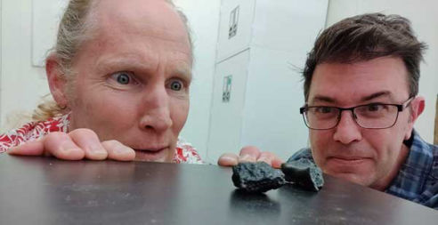 Matt Morgan and James Hagadorn in awe of two Tissint meteorites at the Denver Museum of Nature and Science